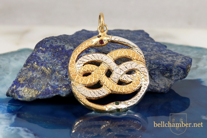 Auryn Pendant in two tone Gold and silver with Ruby and emerald eyes