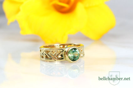 Celtic Key Pattern ring in gold with a 1 carat Green Sapphire