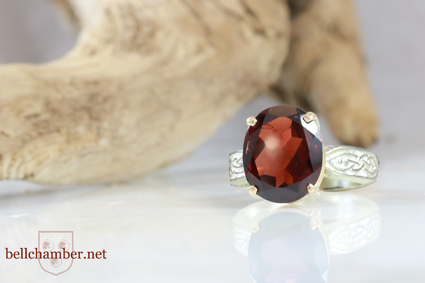 Oval Garnet in Celtic ring with gold claw setting